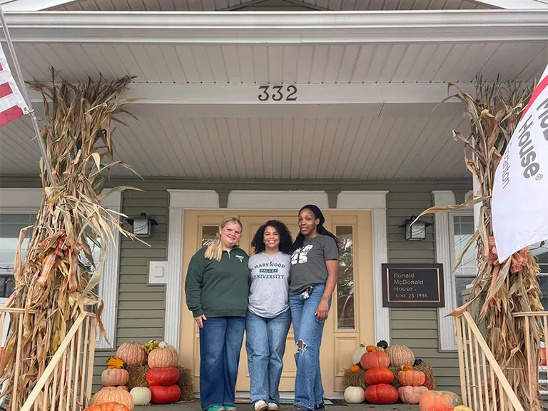 ronald mcdonald house with nursing students standing in front of it